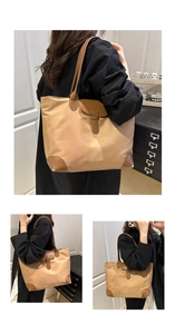 Dettaglio della borsa tote in nylon kaki con manici in pelle marrone indossata dal modello