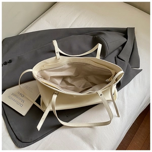 Interior view of large cream tote bag showing spacious compartments and zip pocket