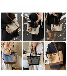 Detail view of multi-color canvas tote bags with leather trim and bear charms