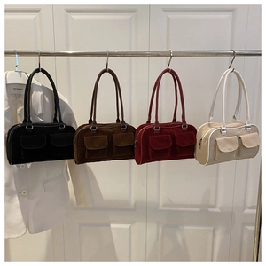 Detail of four retro suede Boston bags in black, brown, burgundy, and beige with buckles