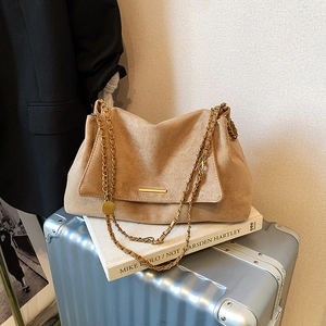 Chic beige suede tote bag with stylish gold chain strap and cloud pleat design