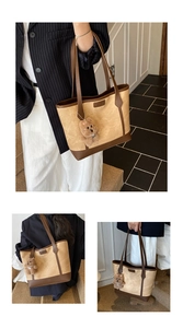 Detail of khaki patchwork tote bag with brown faux leather trim and plush bear charm