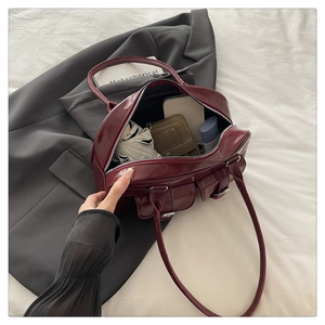 Spacious dark red leather bowling bag interior showing capacity for phone and umbrella
