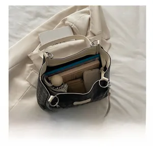 Top view of large checkerboard tote bag interior showing capacity for daily essentials