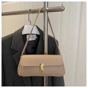Close-up of beige faux leather armpit bag featuring litchi texture and gold metal clasp