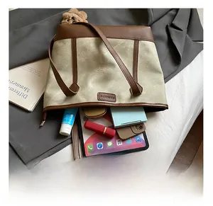 Interior view of large tote bag showing capacity for tablet, phone, and cosmetics