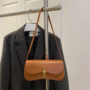 Chic brown baguette shoulder bag in matte leather featuring a gold U-shaped metal buckle