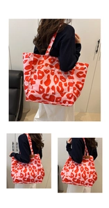 Detailed close-up of large pink leopard print tote bag with metal rivet accents