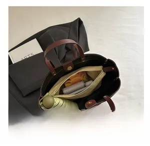 Interior view of brown leather tote bag with canvas inner pouch showing large capacity