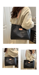 Detail of black quilted tote bag with silver chain straps and large capacity for commuting