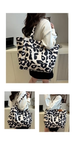 Detail view of large leopard print tote bag featuring a practical front pocket and buttons