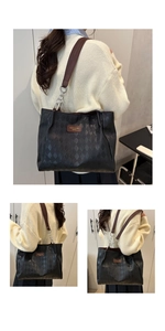 Detail of black quilted tote bag with chain strap and brown leather handle on a model