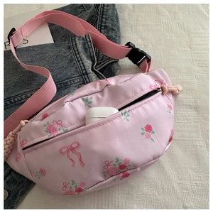 Detail of pink floral waist bag showing interior capacity with a wireless earphone case