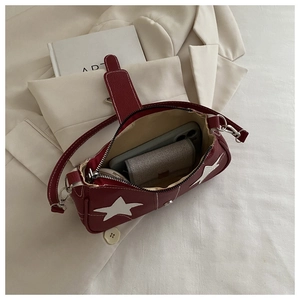 Internal view of burgundy star shoulder bag showing space for phone and lipstick