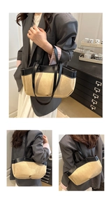 Detail of minimalist contrast tote bag with beige canvas and black leather shoulder straps