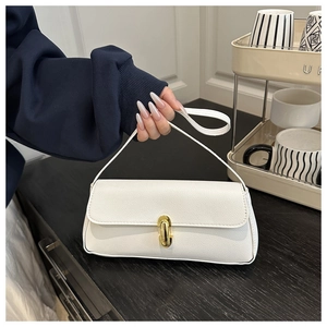 Detail of white lychee grain leather underarm bag featuring elegant gold metal twist lock