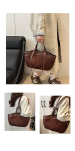 Close-up of brown suede tote bag with contrast stitching and leather shoulder straps