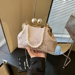 Rosa Jacquard-Muscheltasche mit Perlenverschluss und Kette in der Spiegelreflexion