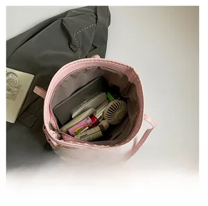 Dettaglio dell'interno della borsa tote rosa che mostra l'ampia capacità contenitiva