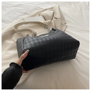 Detail view of large nylon tote bag featuring black checkered pattern and white straps