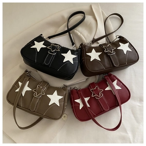 Detailed flat lay of four vintage star patchwork shoulder bags in various classic colors