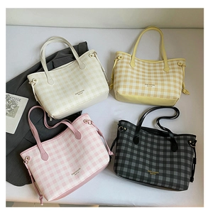 Detailed flat lay of checkered tote bags in four colors with leather straps and drawstring