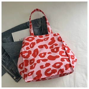 Close-up of leopard print nylon tote bag showing pink fabric and red pattern detail
