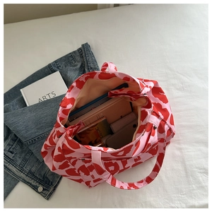 Interior view of leopard print nylon tote bag showing spacious capacity and red pattern