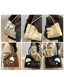 Quilted tote bag in silver, beige, brown, and black with woven handles and cloud charm