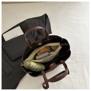 Top view of large dark brown tote bag with inner pouch showing spacious storage capacity