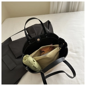 Macro shot of large tote bag interior with zipper pocket and magnetic snap closure