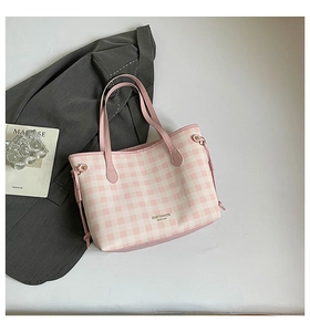 Detail of pink gingham tote bag with letter print and side drawstring accents