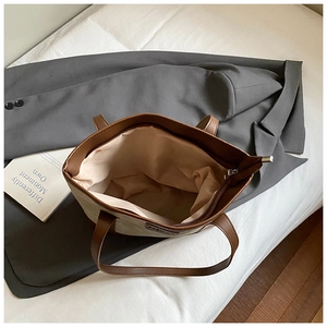 Spacious interior of canvas and leather tote bag showing large capacity and zipper