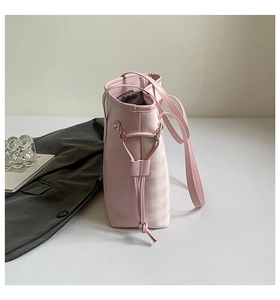Detail of light pink plaid tote bag featuring side drawstring design and PU leather trim
