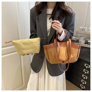Detailed shot of two-piece set featuring brown suede tote bag and canvas inner pouch