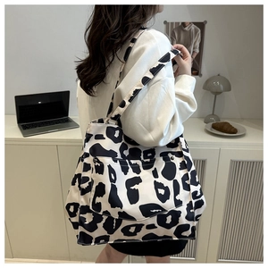 Close-up of leopard print canvas tote bag with functional front metal button pocket