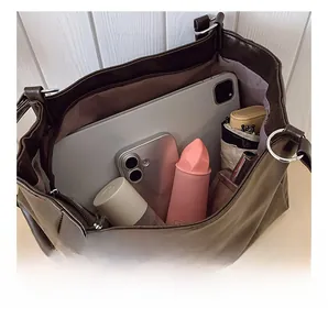 Deep brown leather tote interior showing large capacity for tablet and daily items