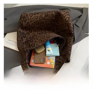 Detailed interior of leopard print tote bag showing capacity for tablet and cosmetics