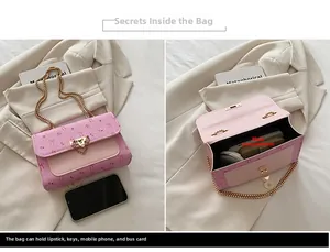 Internal view of pink cherry print shoulder bag showing main storage and gold chain strap