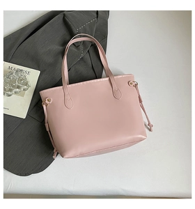 Flat lay of pink tote bag with side drawstring detail next to a stylish grey blazer
