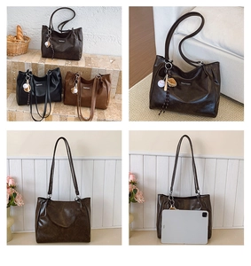Detail of large vintage tote bag in glossy PU leather showing capacity and three colors