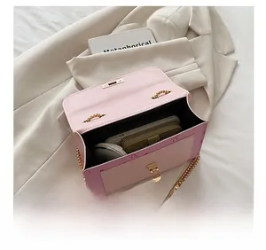 Detail showing pink leather bag interior with space for phone, wallet and headphones