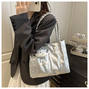 Detailed shot of silver quilted tote bag with chain strap and fluffy cloud pendant charm