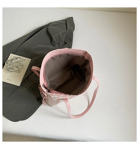 Detail view of pink and white checkered tote bag featuring inner zip pocket and fabric lining