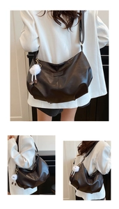 Three-way view of a black pebble leather hobo bag featuring a white plush charm