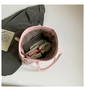 Top view detail of large capacity pink checkered tote bag showing spacious interior items