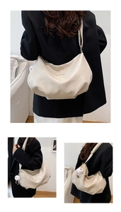 Close-up of off-white hobo bag with wide shoulder strap and cute plush charm detail