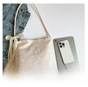 Size comparison of checkered shoulder bag with iPad and phone to show large capacity