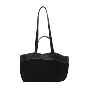 Minimalist black leather tote bag with white contrast stitching and dual handle design