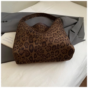 Detailed close-up of leopard print tote bag fabric and soft texture on white background
